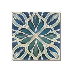 a blue and white tile with leaves on it