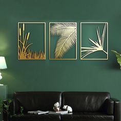 a living room with green walls and black leather couches in front of the wall