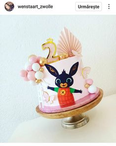 a pink cake with an animal on it