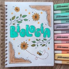 a notebook with the word biosia written on it next to some crayons