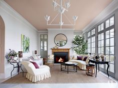 a living room filled with furniture and a fire place in the middle of a room