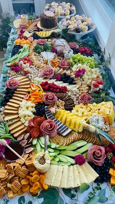 a long table filled with lots of different types of food on top of each other