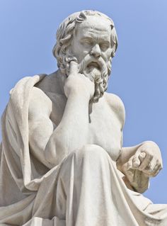 an image of a statue with his hand to his face and the sky in the background