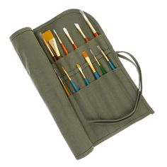 the case is holding seven brushes and two pencils in it, which are lined up on top of each other