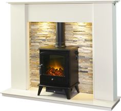 a wood burning stove in front of a brick wall with a lit fire place on top