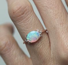 A gorgeous prong set Australian opal & diamond cluster engagement ring in 14k or 18k solid gold or platinum. The opal shines in a variety of special colors (blue, green, white, pink, ...). Lots of fire! This unique multi stone engagement, wedding or bridal cluster is available in 14k and 18k solid rose, white, yellow gold and platinum. Please select the material and ring size from the drop-down menu on the right side of the listing. If you have any questions, please send us a message. If you Oval Opal Ring, Gold Opal Ring, Ruby Wedding Rings, Rose Gold Opal Ring, Australian Opal Ring, Rose Gold Engagement Ring Vintage, Opal Engagement Ring, Solid Gold Bracelet, Purple Amethyst Ring