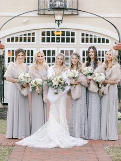 a bride and her bridal party in front of a building