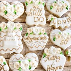 decorated cookies are arranged in the shape of hearts and flowers with words that say we still do