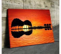 a painting of a guitar on the water at sunset