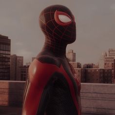 a spider - man standing in front of a city skyline