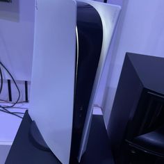 a white and black computer tower next to speakers