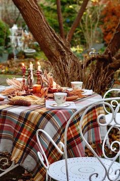 the table is set for two outside in the fall