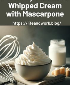 whipped cream in a white bowl on top of a wooden table with utensils