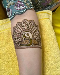 a woman's arm with henna tattoos on it