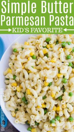 a white plate topped with pasta and peas next to a blue bowl filled with macaroni salad