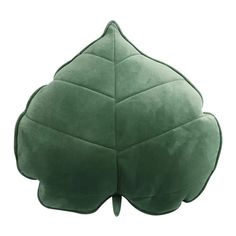 a green leaf shaped pillow sitting on top of a white floor