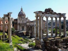 an aerial view of the roman ruins with people walking around them and buildings in the background