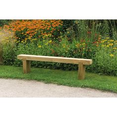 a wooden bench sitting in the middle of a lush green field with wildflowers