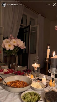 a table filled with food and candles on top of it