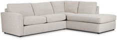 a white sectional couch sitting on top of a white floor