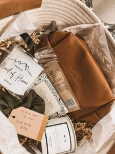 a basket filled with personal care items on top of a white cloth covered floor next to a brown bag