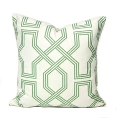 a green and white pillow on a white background