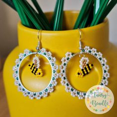 Feeling all summer vibes with these cheery daisy beaded hoop earrings with beaded bee charms.  These earrings are light and comfortable to wear all long. These are made with high quality Miyuki Delica beads with a pearl finish to the daisies, real 24k gold coated beads for the flower centres and bee wings which bring interest, light and life.  The earring hooks are sterling silver and the hoops are silver plated.  These come gift wrapped with earring backs included.  These are handmade with care, patience and love by me here in the Scottish Highlands. The bees hang from the hoop and move freely, catching the light and dancing between the flowers.  These would be perfect for summer holidays and would make a great gift for someone special or as a special treat for yourself. The hoops measure Patience And Love, Bee Wings, Beaded Earrings Native, Beaded Lanyard, Miyuki Delica Beads, Seed Beading, Beaded Lanyards, Beaded Earrings Patterns, Bee Charms