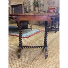 an old wooden table sitting on top of a carpeted floor