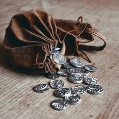 a drawstring bag filled with lots of silver coins