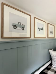 three framed pictures hang on the wall above a bench with a black and white checkered floor