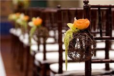 the chairs are lined up with flowers on them