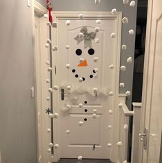 a door decorated with snowmen and bows