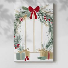 a christmas card with holly, mist and bows on the front in white paper against a grey background