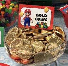 a bowl full of gold coins with a sign that says, gold coins super mario