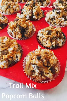 a red tray filled with cupcakes covered in toppings