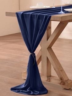 the table is covered with blue cloths and place settings for two people to sit at