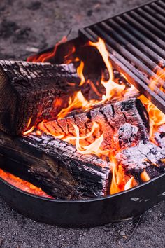 an open grill with flames on the ground