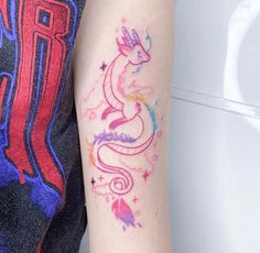 a woman's arm with a colorful tattoo design on the left side of her arm