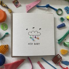 a new baby card surrounded by toys