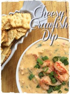 a bowl of shrimp dip with crackers on the side