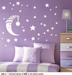 a bedroom with purple walls and white stars