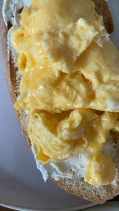 an open faced sandwich with eggs and cheese on it