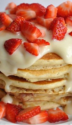 a stack of pancakes with strawberries on top