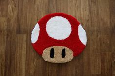 a mushroom rug is on the floor with a wooden floor in front of it,