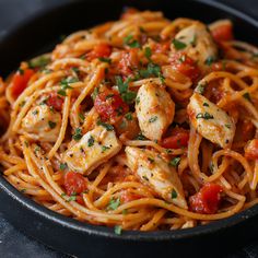 pasta with chicken and tomatoes in a skillet