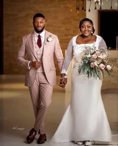 a bride and groom are walking down the aisle holding hands in front of each other