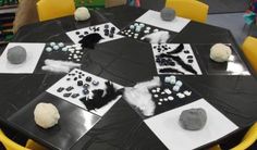 a black table topped with lots of white and grey items on top of it's surface