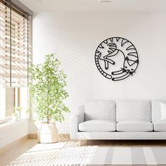 a living room with a white couch and a black clock on the wall above it