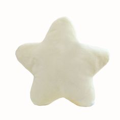 a white star shaped pillow sitting on top of a table