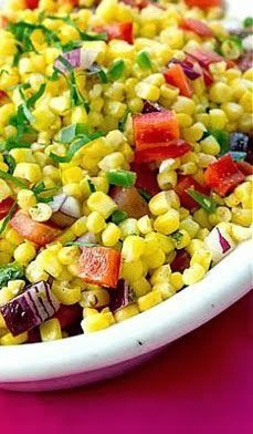 a white bowl filled with corn and vegetables